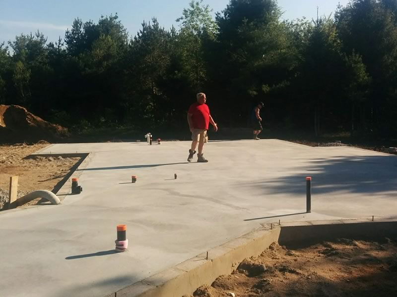 A freshly poured slab on grade with plumbing stubs, on The Bayview, an A&R build in Oro-Medonte, in 2018